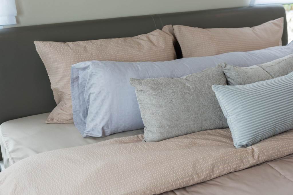 set of pillows on king bed size in luxury bedroom