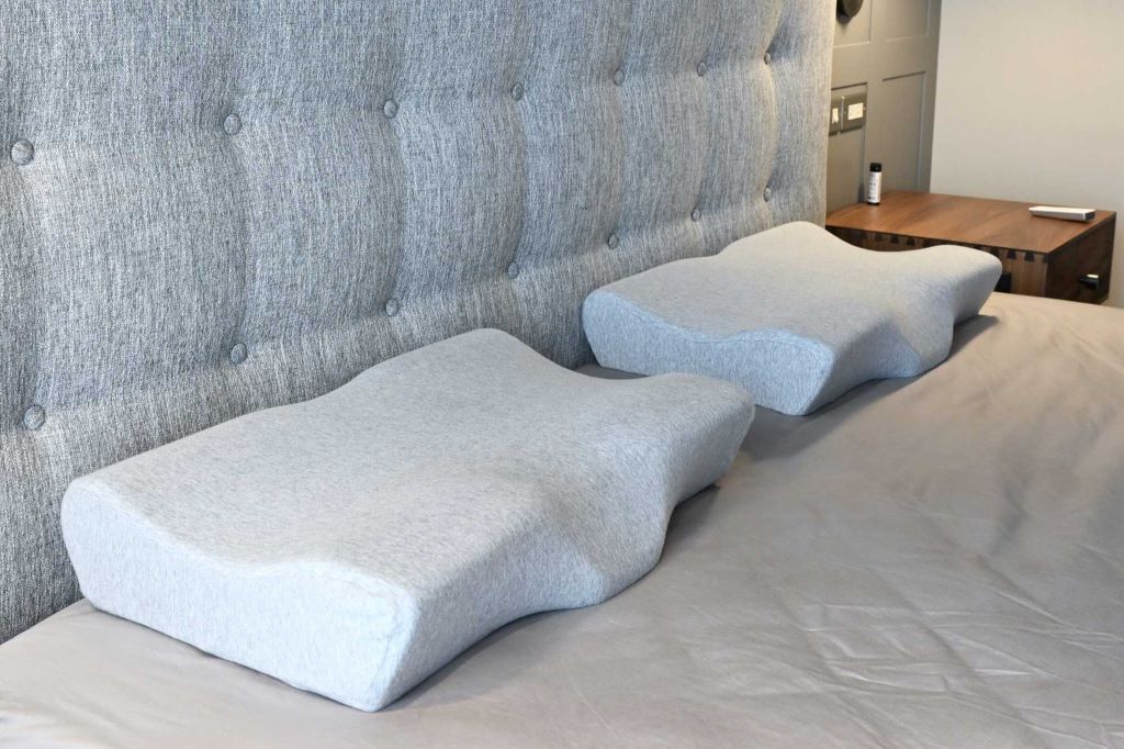 Bedroom scene showing ergonomic cervical pillow used for improved neck comfort and pain relief